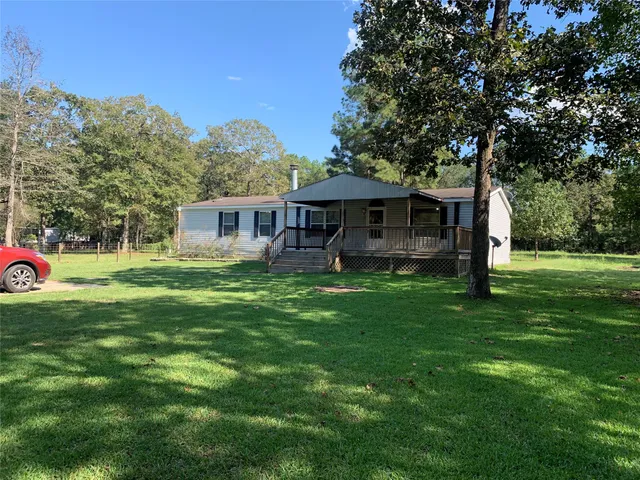 a front view of a house with a yard table and chairs