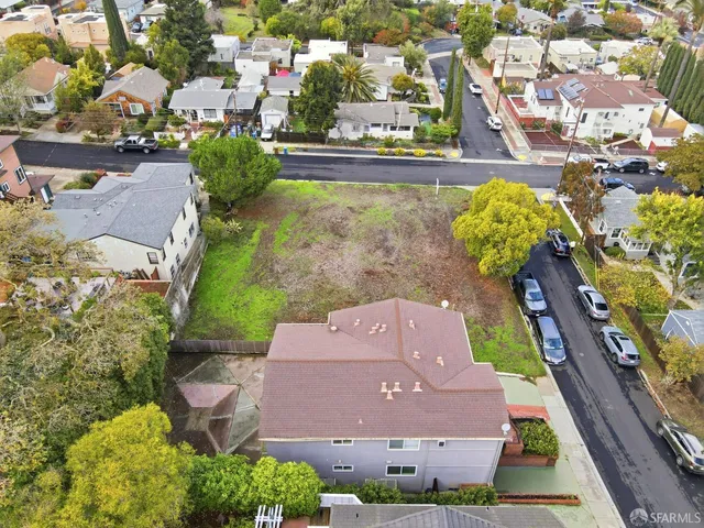 an aerial view of a house with a yard and lake view