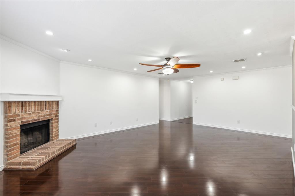 3804 McClintick Road McKinney, TX 75070 - Photo 12 of 32 wooden floor in an empty room with a fireplace