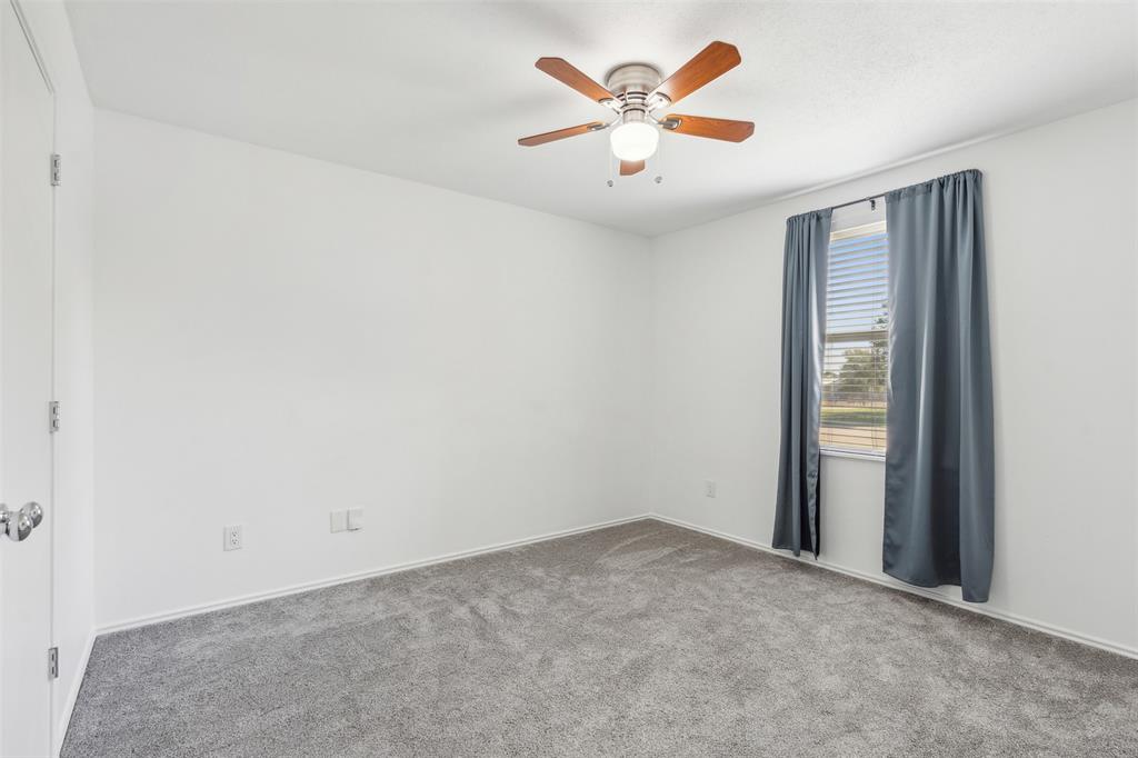 3804 McClintick Road McKinney, TX 75070 - Photo 16 of 32 an empty room with a window and a ceiling fan