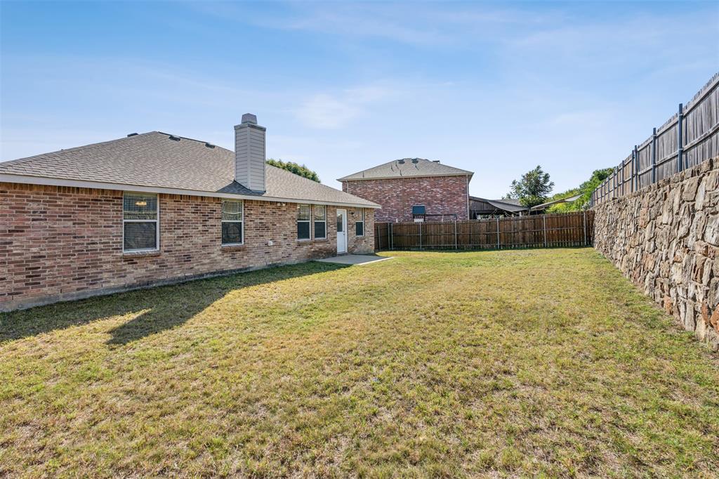 3804 McClintick Road McKinney, TX 75070 - Photo 26 of 32 a front view of a house with a big yard and large tree