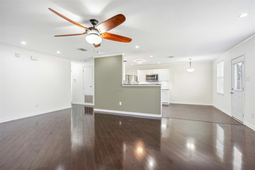 3804 McClintick Road McKinney, TX 75070 - Photo 6 of 32 an empty room with wooden floor fan and windows