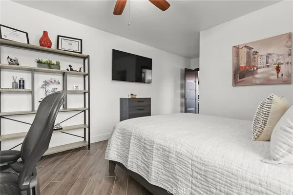 a bedroom with a bed and a large window