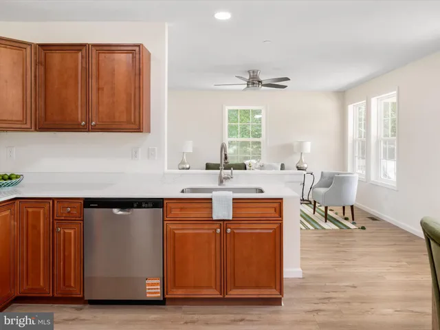 a kitchen with stainless steel appliances granite countertop a sink and a wooden cabinets
