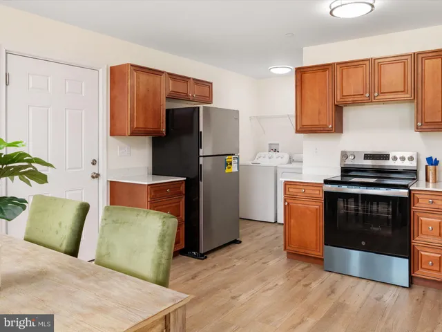 a kitchen with stainless steel appliances granite countertop a refrigerator a stove a sink and a microwave