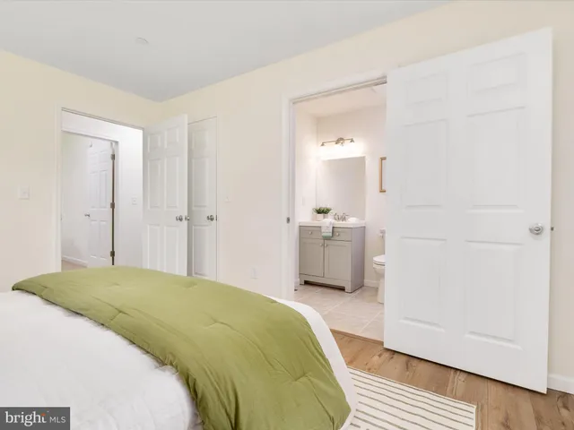 a spacious bedroom with a bed and a view of bathroom