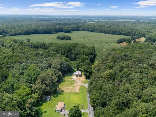 an aerial view of a houses with outdoor space and city view