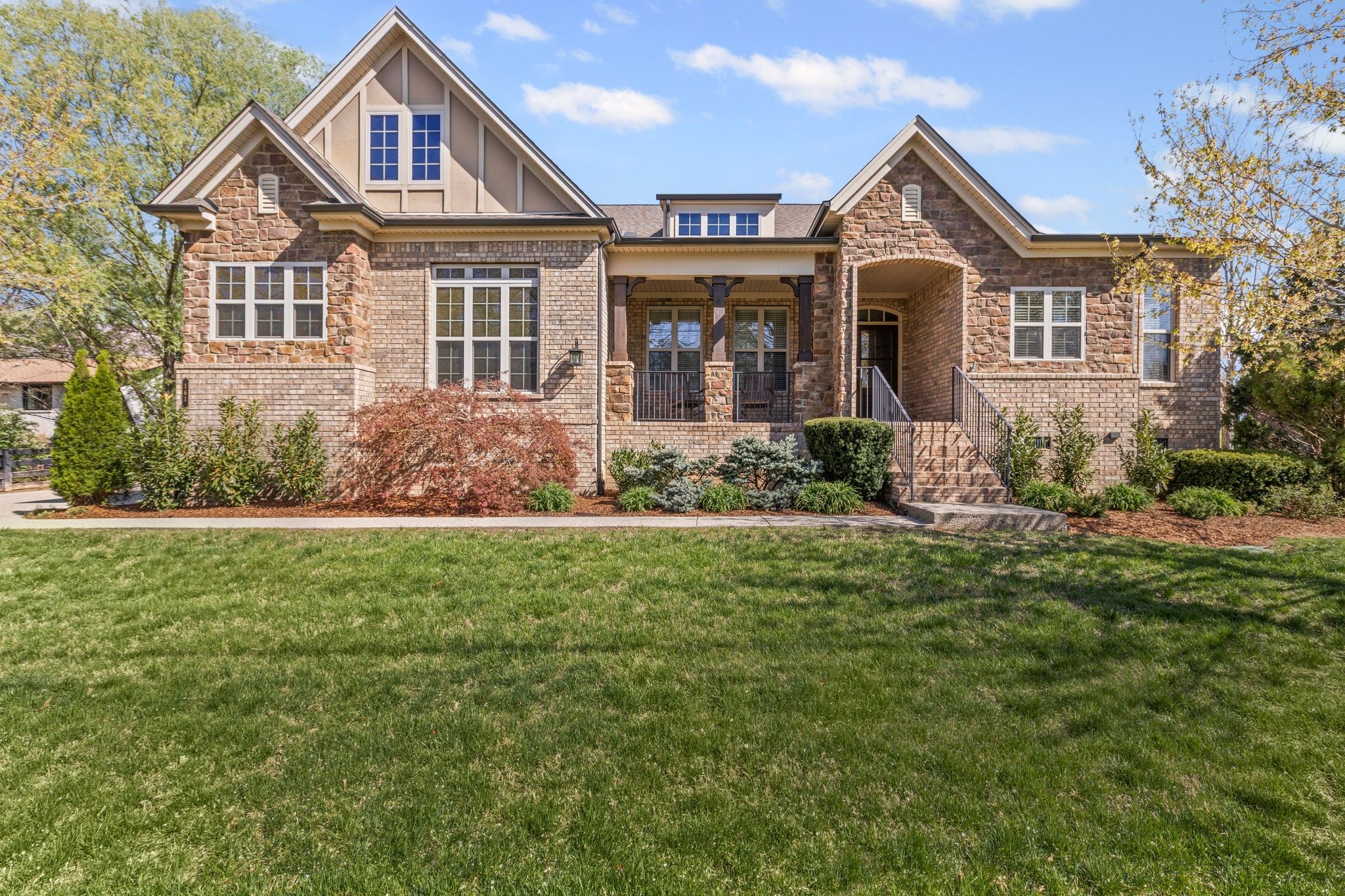 a front view of a house with garden
