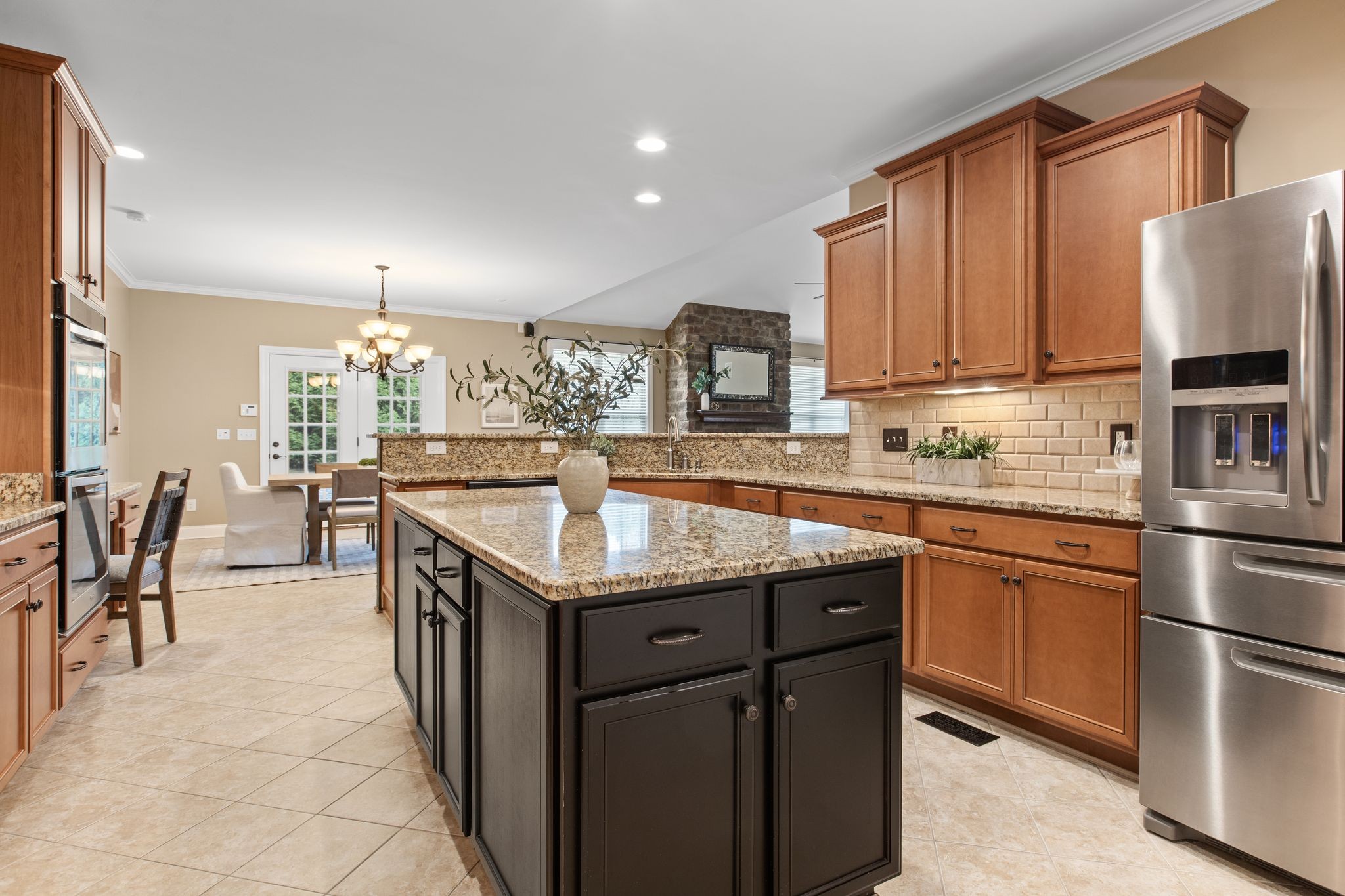 161 Chester Stevens Road Franklin, TN 37067 - Photo 12 of 37 a kitchen with stainless steel appliances granite countertop a table chairs sink and cabinets