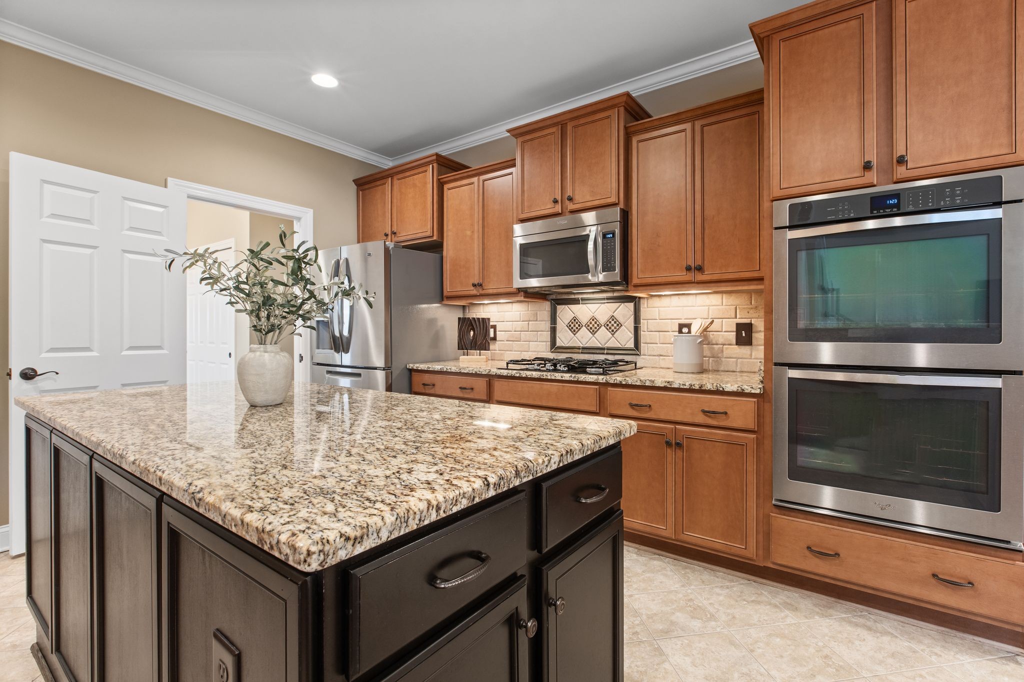 161 Chester Stevens Road Franklin, TN 37067 - Photo 13 of 37 a kitchen with stainless steel appliances granite countertop a sink dishwasher stove and microwave with wooden cabinets