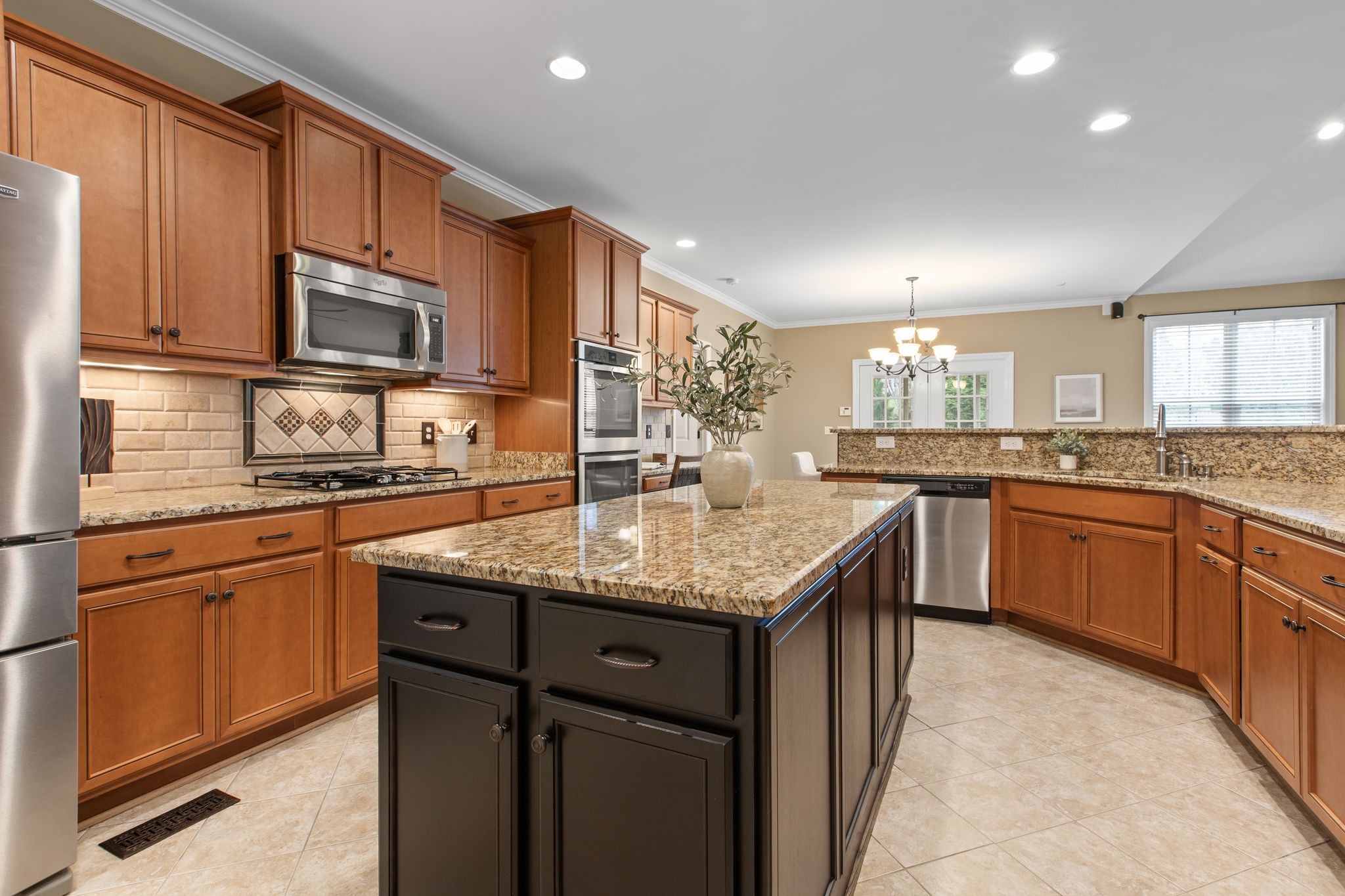 161 Chester Stevens Road Franklin, TN 37067 - Photo 14 of 37 a kitchen with stainless steel appliances granite countertop a sink stove microwave and cabinets