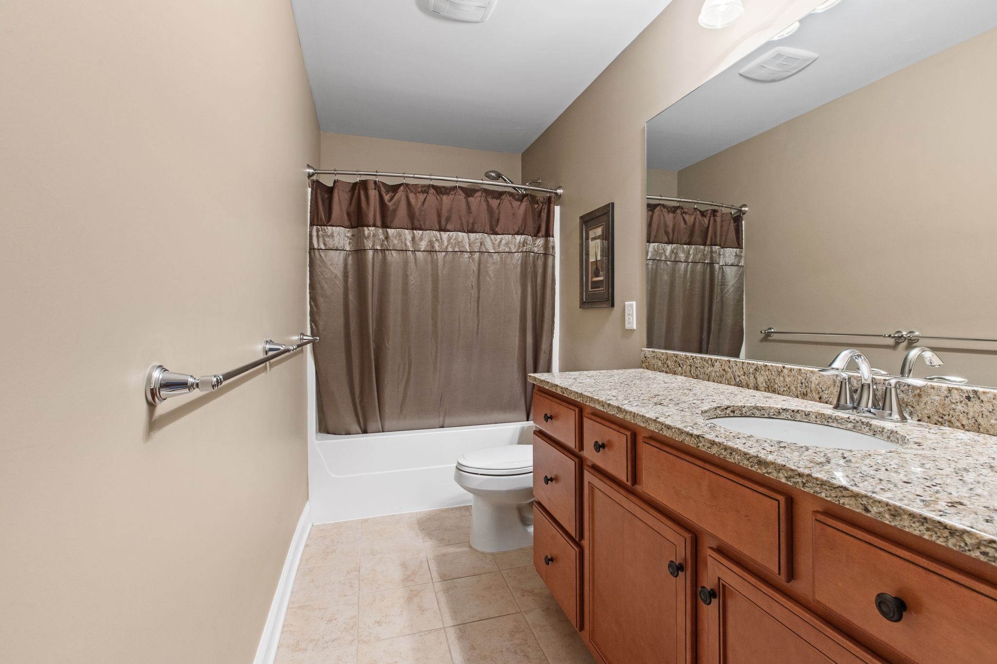 161 Chester Stevens Road Franklin, TN 37067 - Photo 28 of 37 a bathroom with a granite countertop sink a toilet a mirror and shower