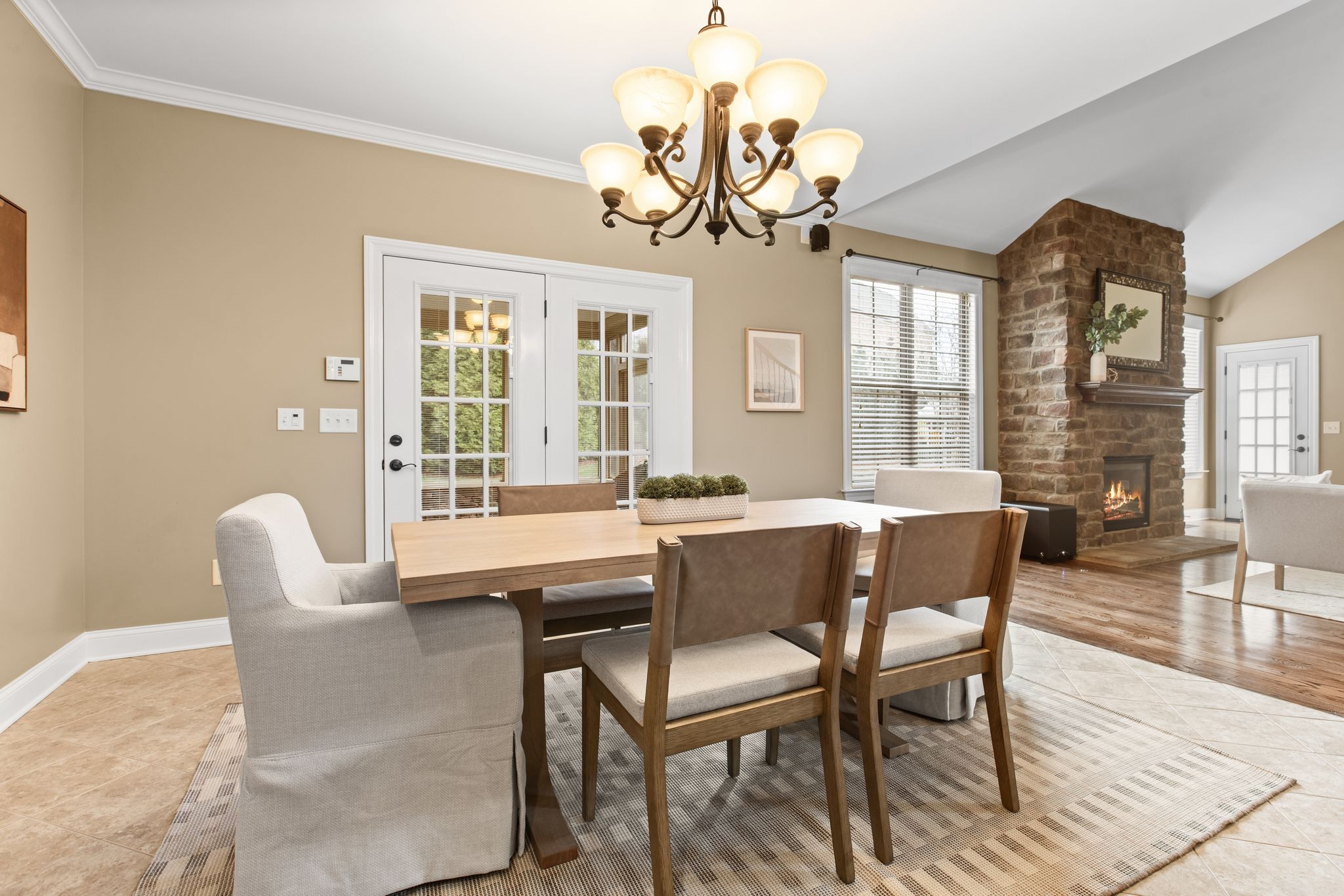 161 Chester Stevens Road Franklin, TN 37067 - Photo 10 of 37 a dining room with wooden floor a chandelier a wooden table and chairs