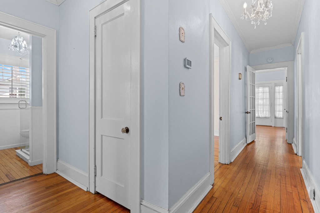 46 Dillard Street Murphy, NC 28906 - Photo 69 of 73 a view of a hallway with wooden floor and a bathroom