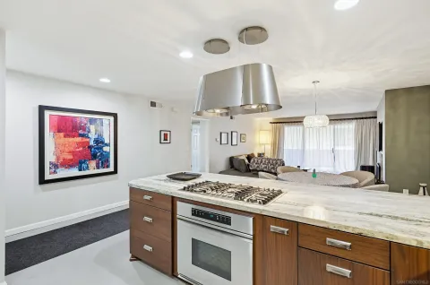 a kitchen with stainless steel appliances granite countertop a stove and a sink