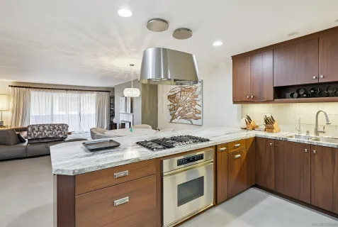 a kitchen with stainless steel appliances granite countertop a sink stove and cabinets