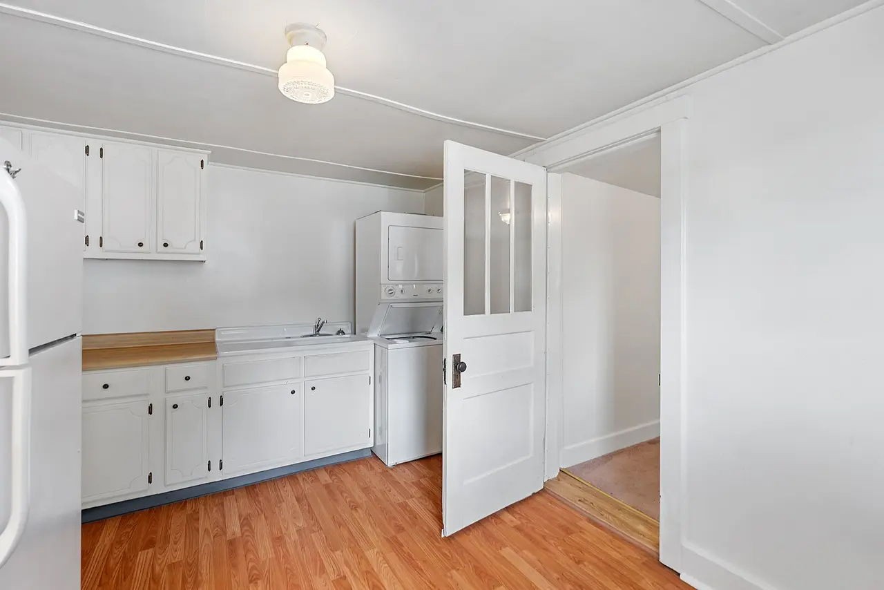 702 Richard Street Springfield, TN 37172 - Photo 11 of 15 a kitchen with white cabinets and wooden floor