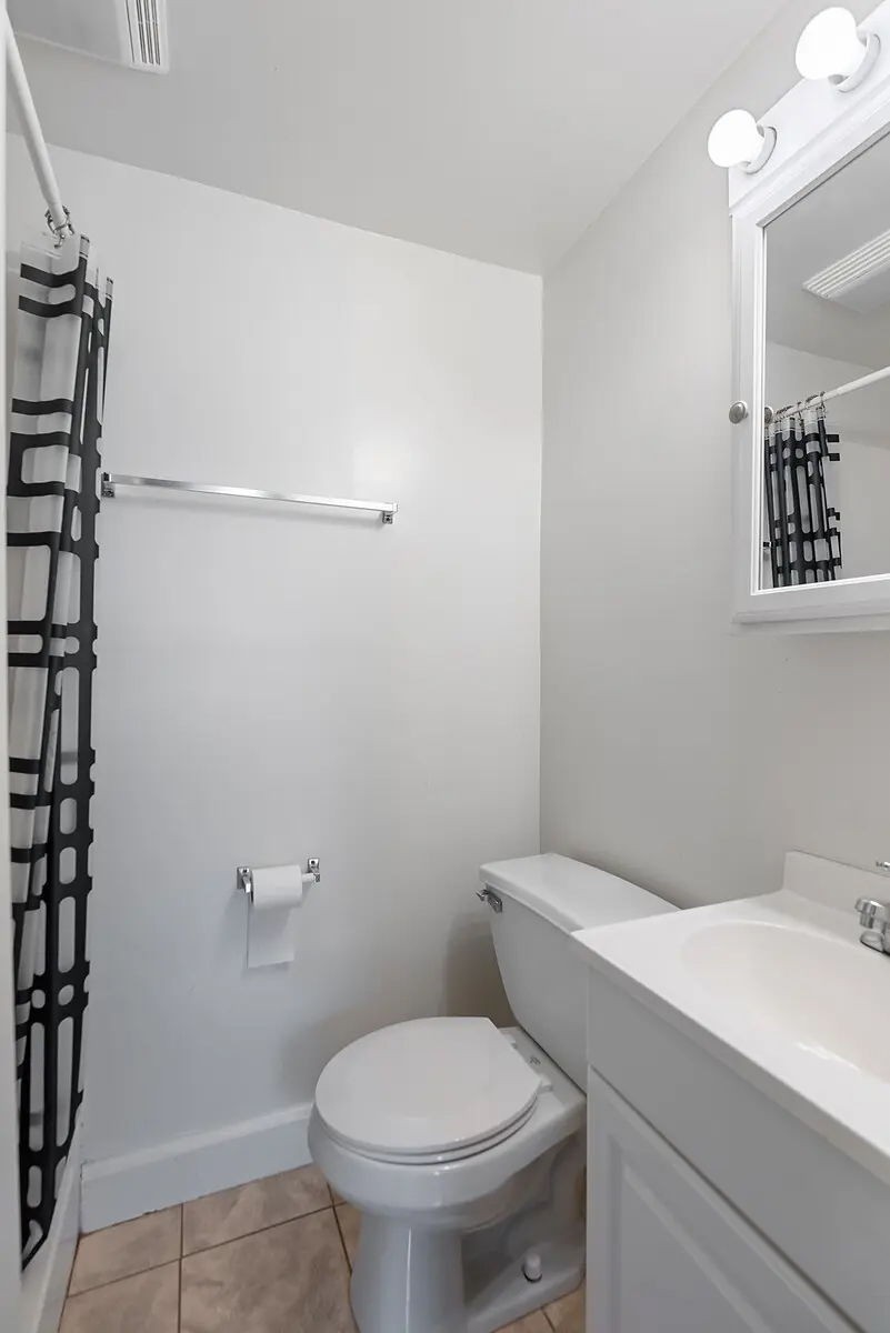 702 Richard Street Springfield, TN 37172 - Photo 12 of 15 a white toilet sitting next to a bathroom sink