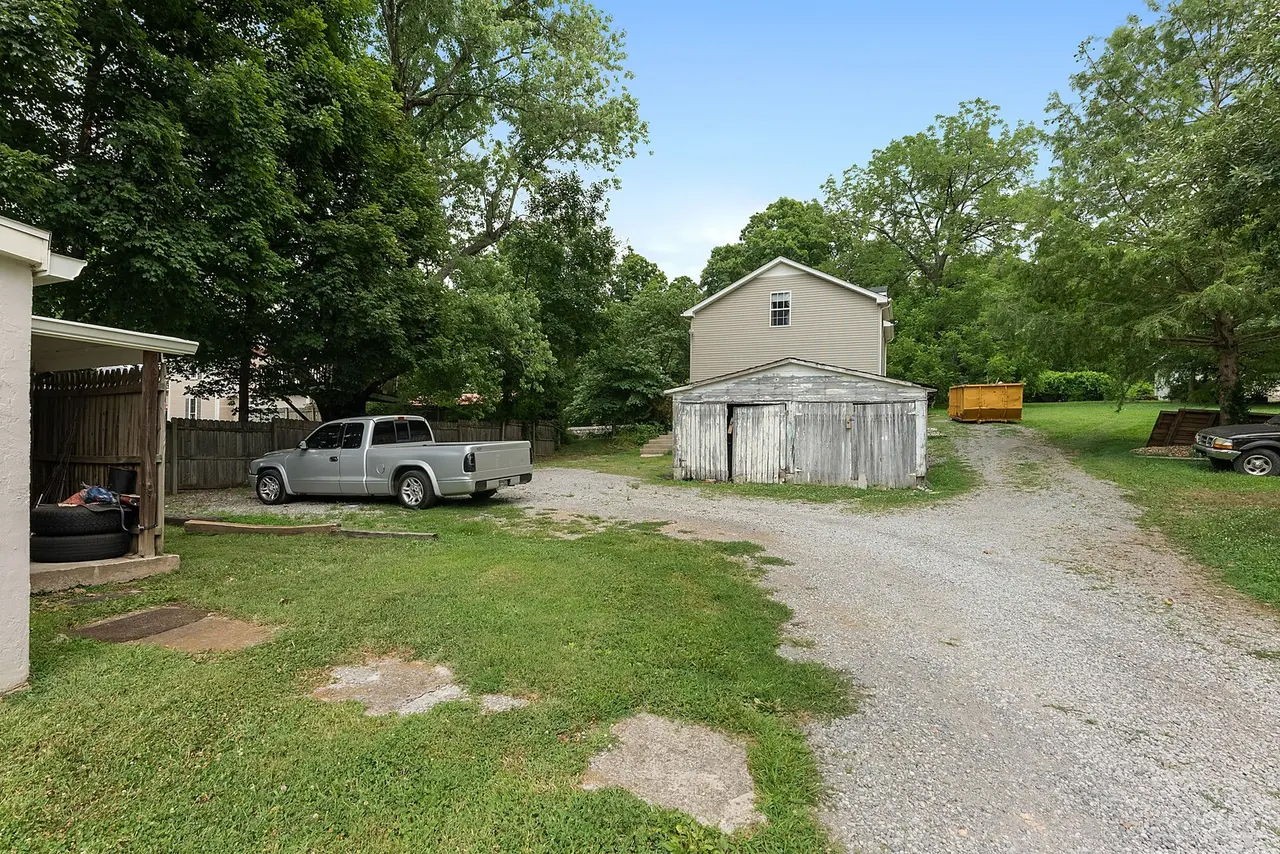 702 Richard Street Springfield, TN 37172 - Photo 15 of 15 a front view of a house with a garden and parking space
