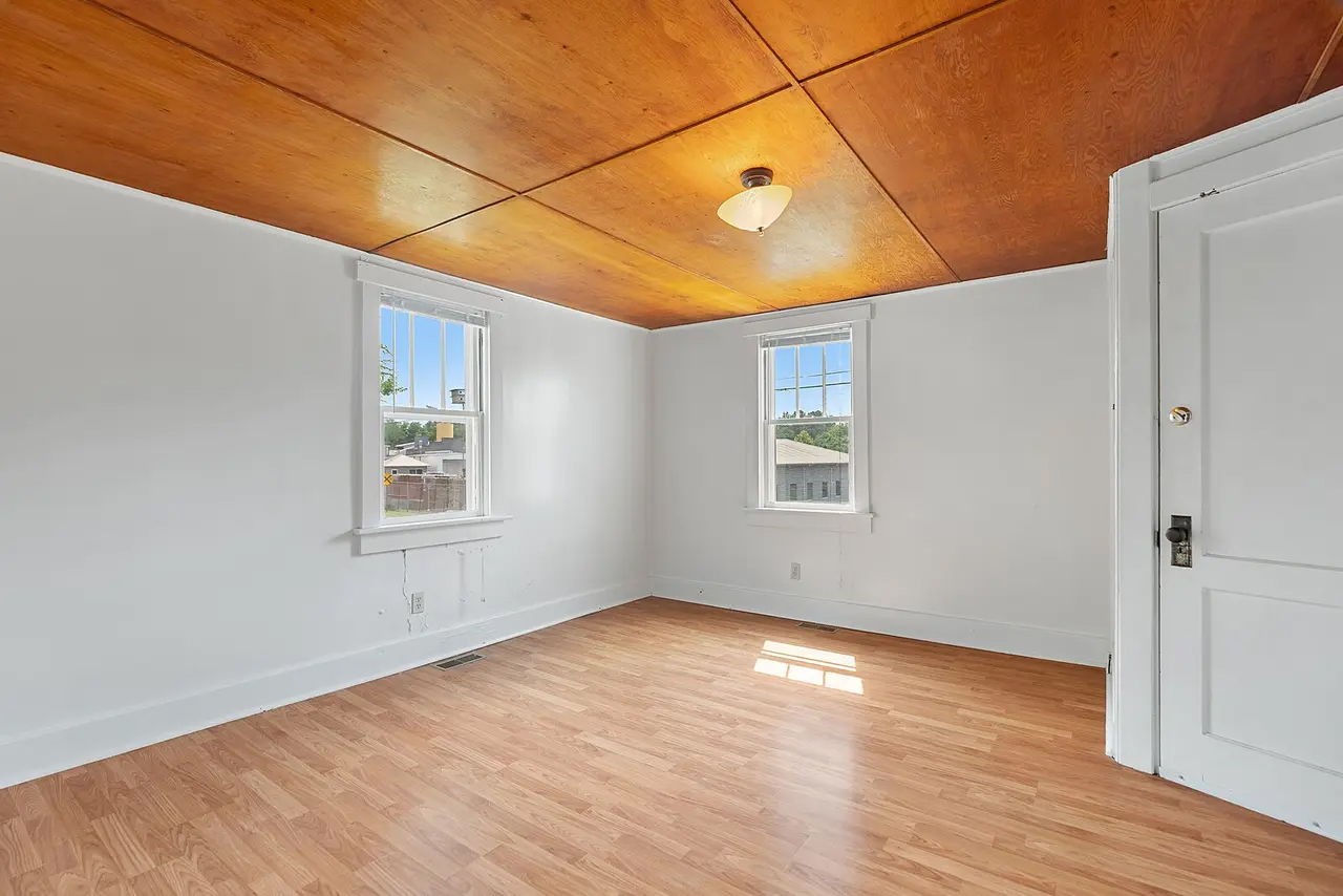 702 Richard Street Springfield, TN 37172 - Photo 3 of 15 an empty room with wooden floor and windows