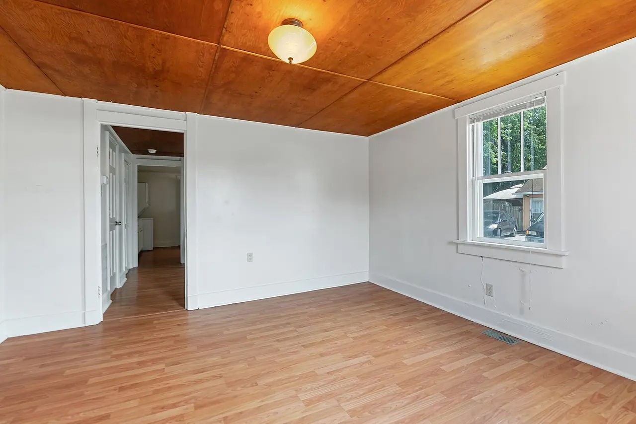 702 Richard Street Springfield, TN 37172 - Photo 4 of 15 an empty room with wooden floor and windows