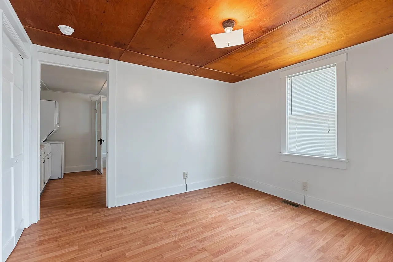702 Richard Street Springfield, TN 37172 - Photo 5 of 15 an empty room with wooden floor and windows