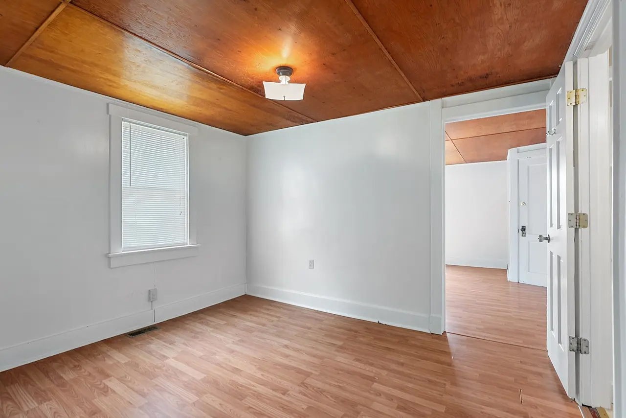702 Richard Street Springfield, TN 37172 - Photo 8 of 15 a view of an empty room with wooden floor and a window