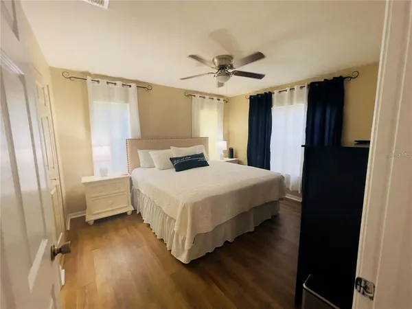 a bedroom with a bed and a chandelier