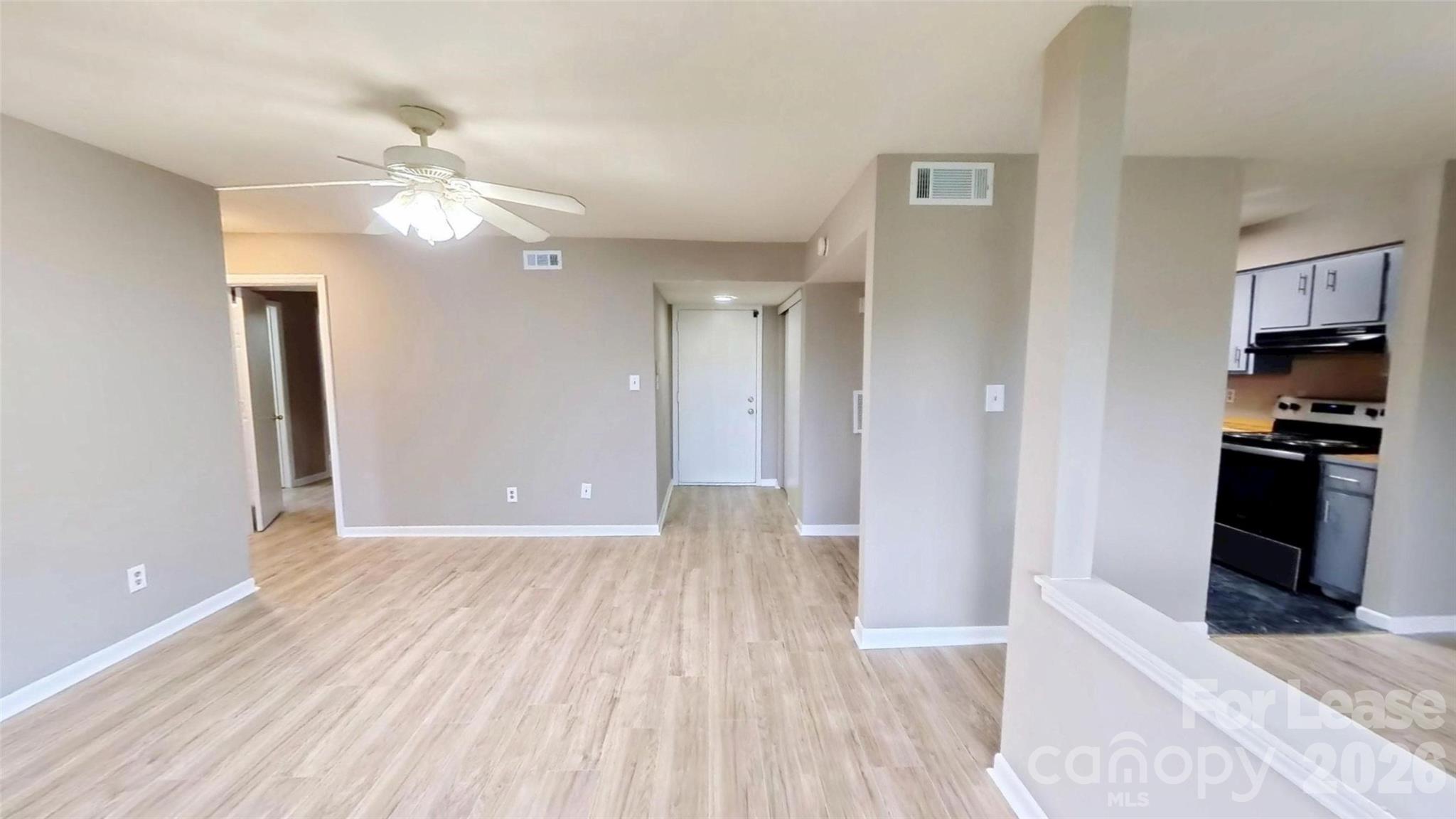 11139 Harrowfield Road Charlotte, NC 28226 - Photo 3 of 6 a view of a kitchen with wooden floor and a ceiling fan