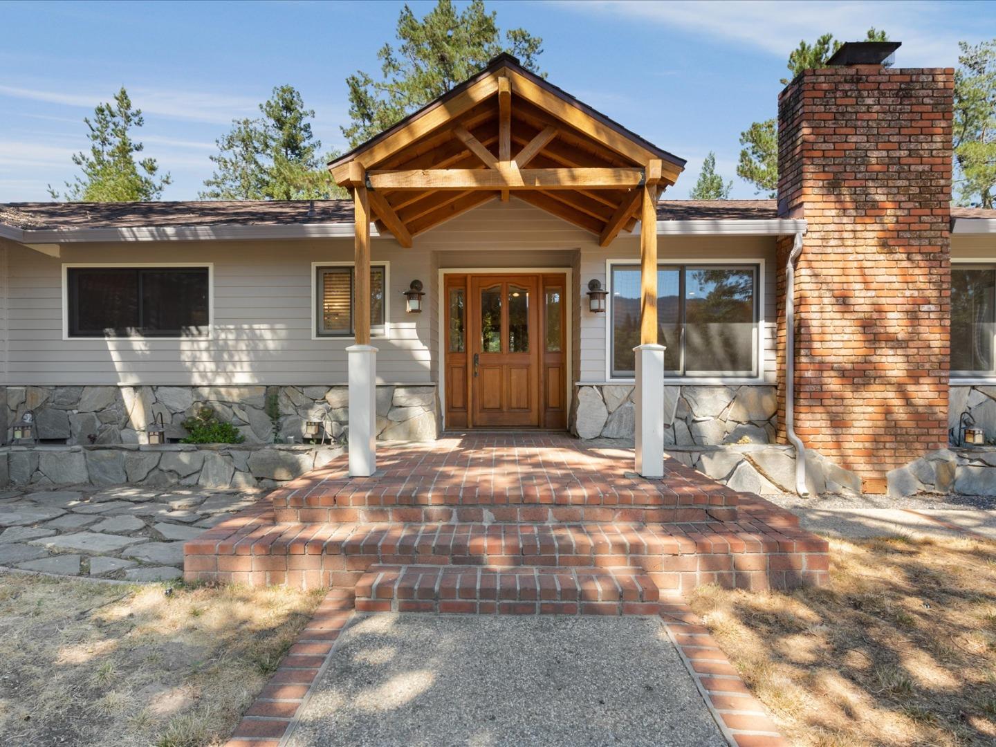 1395 Cañada Road Woodside, CA 94062 - Photo 1 of 36 a front view of a house with a yard