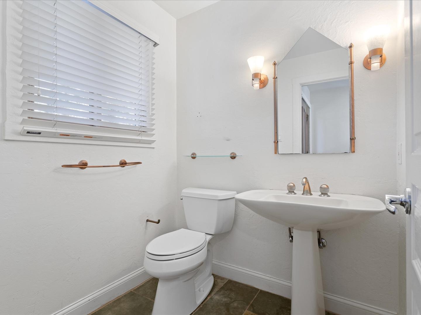 1395 Cañada Road Woodside, CA 94062 - Photo 7 of 36 a bathroom with a toilet a sink and mirror