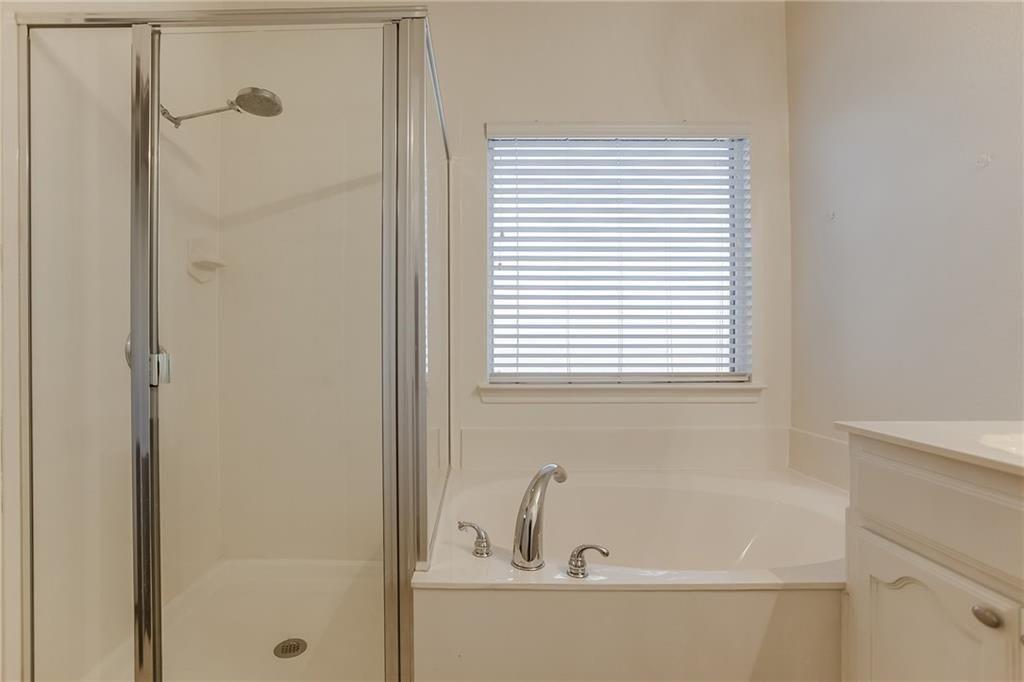 3817 Summersville Lane Fort Worth, TX 76244 - Photo 11 of 18 a bathroom with a bathtub and a window