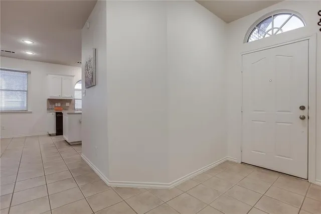 a kitchen with kitchen island granite countertop a sink appliances and cabinets