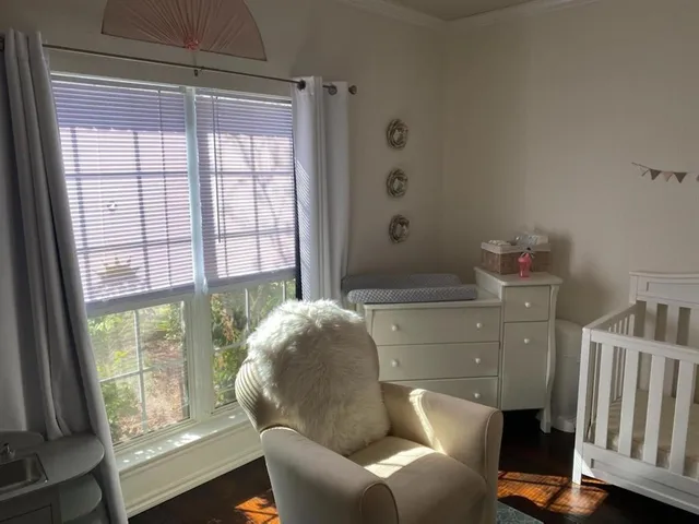 a bed sitting in a bedroom next to a window