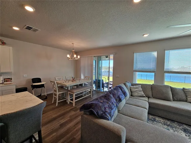 a kitchen with a refrigerator a sink and dishwasher with wooden floor