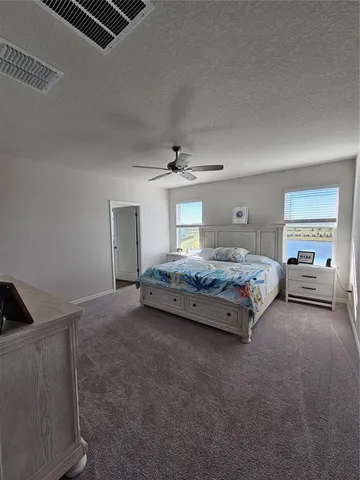 a bedroom with a bed a desk and chair