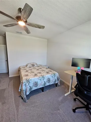 a view of a hallway with workspace and mirror