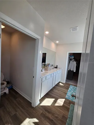 a bedroom with a bed and ceiling fan