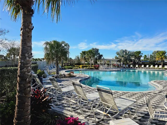 a view of swimming pool with outdoor seating and city view