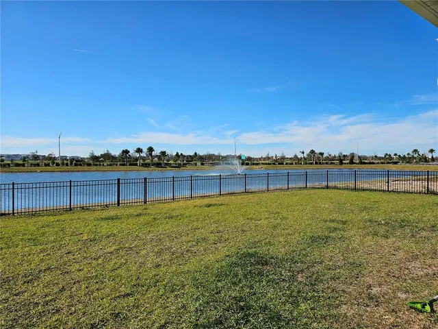 a view of a lake with houses in the background
