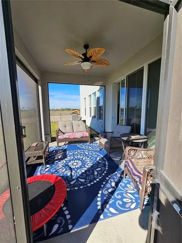 a living room with lots of furniture and view of kitchen