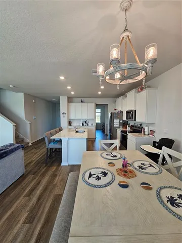 a living room with furniture a large window and a rug