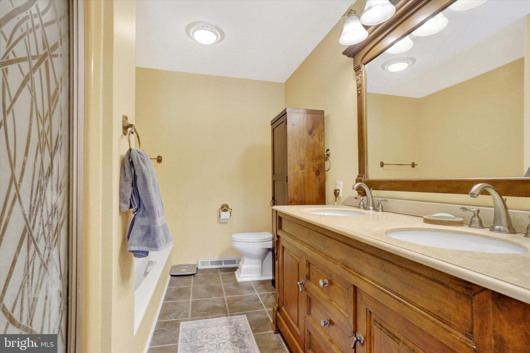 2350 Sutton Road York, PA 17403 - Photo 19 of 37 a spacious bathroom with a double vanity sink and a mirror