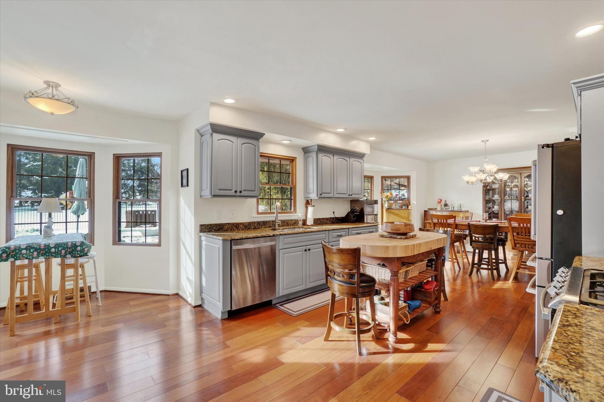 2350 Sutton Road York, PA 17403 - Photo 8 of 37 a large dining hall with stainless steel appliances granite countertop a stove top oven a dining table and chairs with wooden floor
