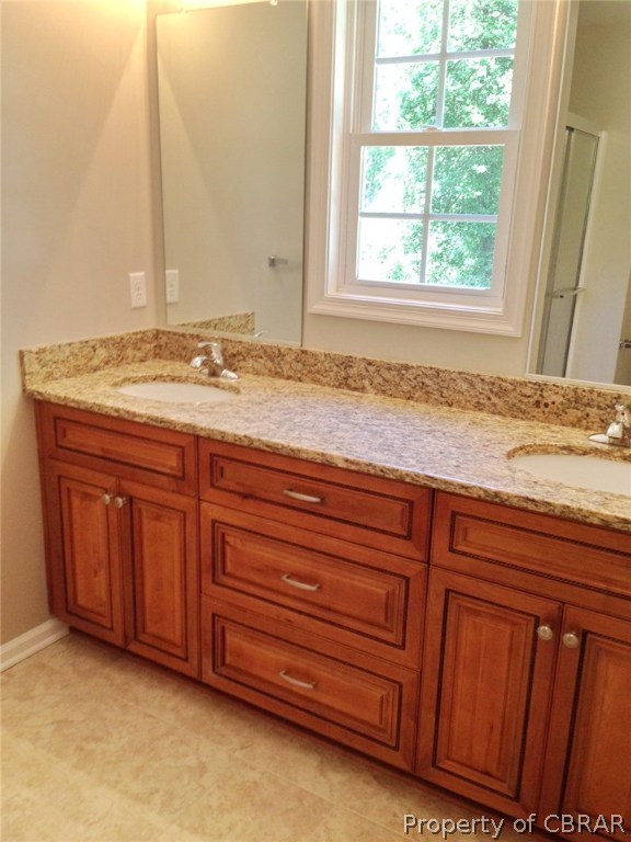 67 River Rd Circle Saluda, VA 23149 - Photo 11 of 13 Granite double vanity in master bath, ceramic tile floors.