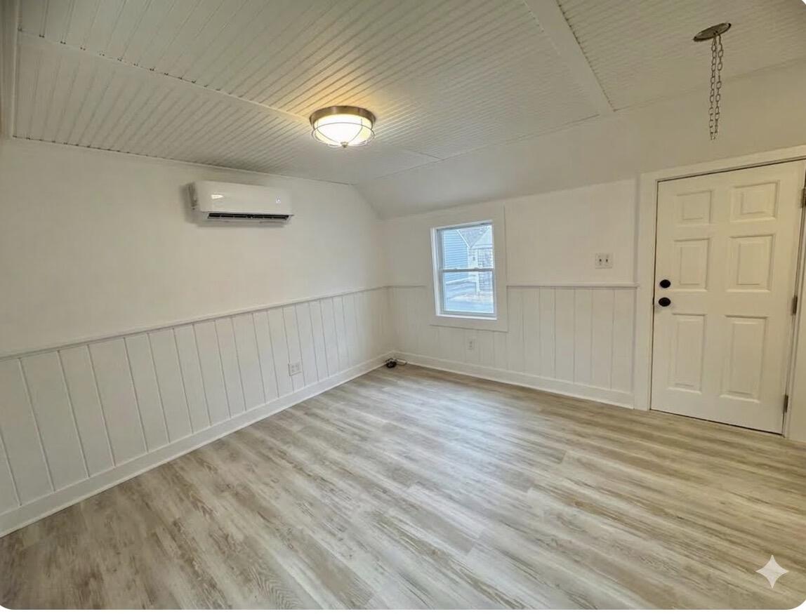 376 Route 6A, Unit 6 Sandwich, MA 02537 - Photo 2 of 6 an empty room with wooden floor and windows