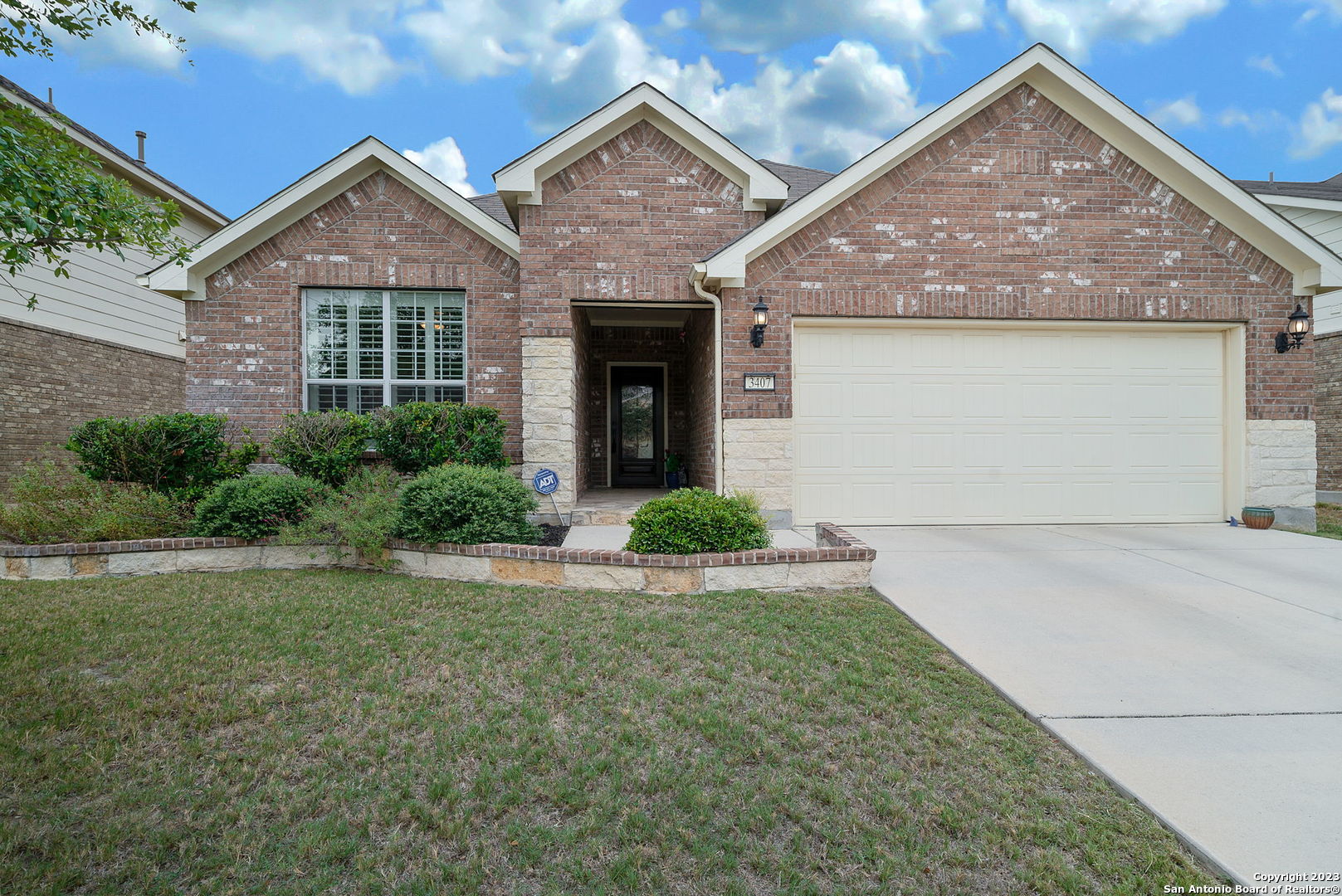 a front view of a house with a yard and garage