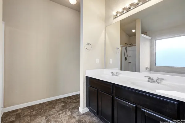 a bathroom with a sink a mirror and a vanity