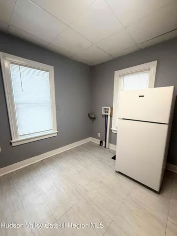 a view of a room with a sink and a refrigerator