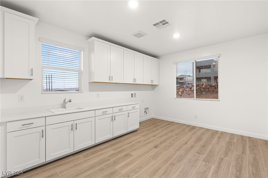 522 Riley Ridge Henderson, NV 89012 - Photo 30 of 53 Upstairs laundry room with plenty of cabinetry